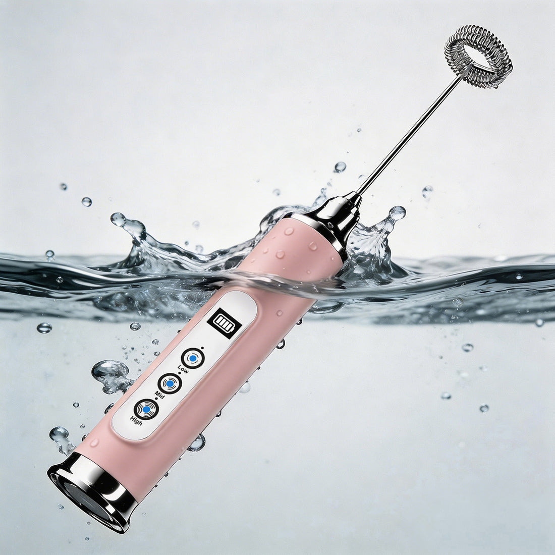 Pink milk frother with whisk attachment in water on a light gray background