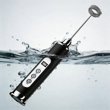 Black handheld milk frother with digital display in water
