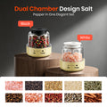 Dual chamber salt and pepper shaker set with black and white options on a wooden platform.