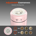 Pink spice grinder with adjustment coarseness feature on a gray background