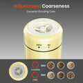 Gold-colored spice grinder with adjustment coarseness feature on a gray background