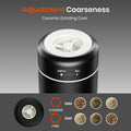 Black ceramic grinder with adjustment coarseness feature on a gray background