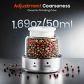 Pepper grinder with adjustable coarseness feature, filled with multicolored peppercorns.