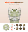 Green ceramic grinder with adjustment coarseness feature on a beige background